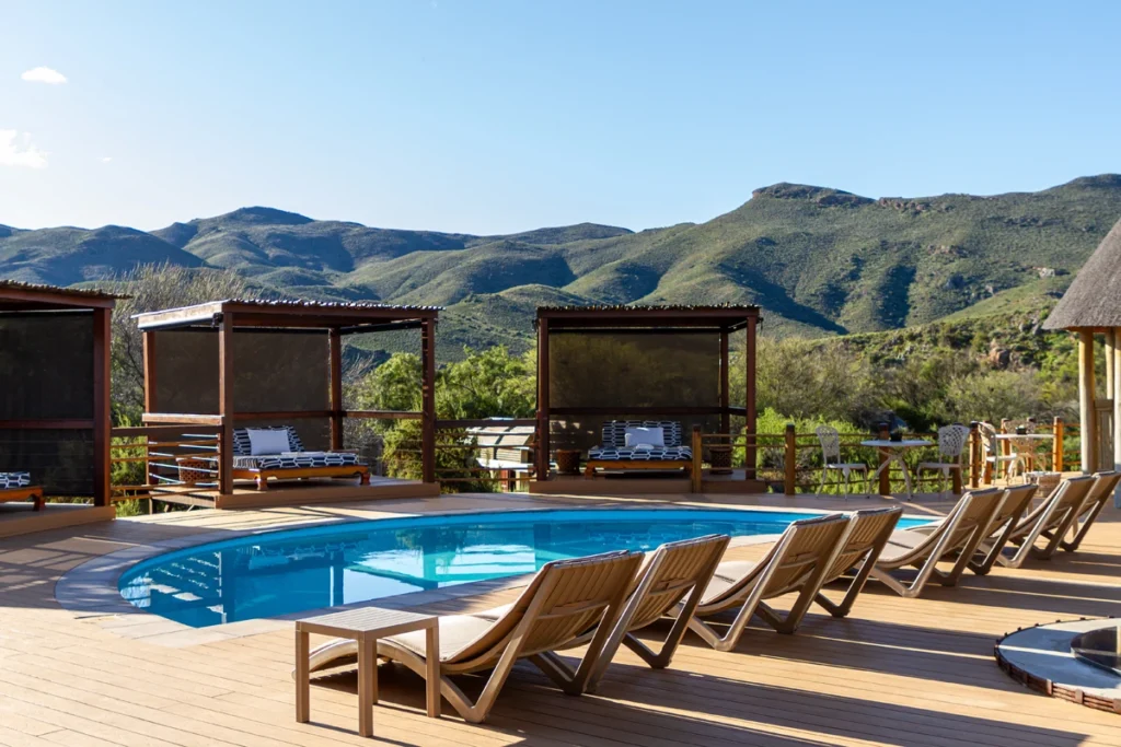 Scenic pool deck at Mont Eco Private Nature Reserve with mountain views and private cabanas, combining tranquillity and five-star eco-luxury.